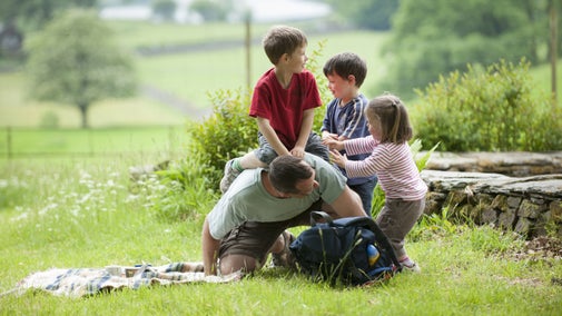 Family playing on the grass at Allan Bank, Grasmere, Cumbria